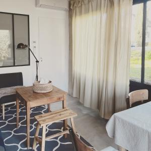 a room with a table and a bed and a window at Maison Saint Georges in Saint-Georges-sur-Cher