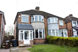 a brick house with white doors and windows at Spacious 3 Bed House in Sheldon 5 min to JLR & NEC in Birmingham