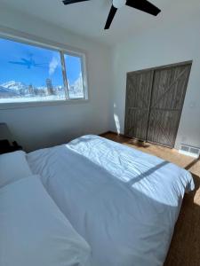 a bedroom with a large bed and a window at Ravens End in Dead Man's Flats