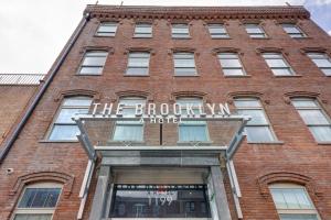 a red brick building with a sign on it at The Brooklyn in Brooklyn