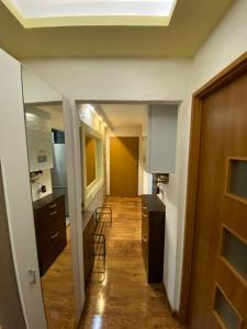 a hallway leading to a kitchen with chairs and a door at Bielawa Góry Sowie in Bielawa