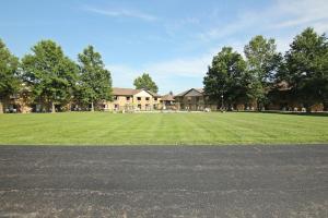 a large field of grass in front of a building at Baymont Inn and Suites by Wyndham Farmington, MO in Farmington