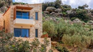 a house on the side of a mountain at Anadia Luxury Pocket Villa in Falasarna