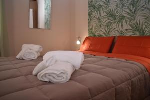 a bedroom with a bed with towels on it at Kanat Apartment in Palermo