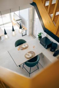 a dining room with a white table and green chairs at Anadia Luxury Pocket Villa in Falasarna