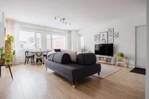 a living room with a couch and a table at Ydinkeskustan designkaksio in Hämeenlinna