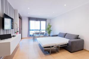 a living room with a couch and a table at Ninel Home Tenerife in Palm-mar