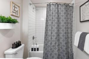 a bathroom with a black and white shower curtain at Luxury Urban 1BR King Bed-Parking - Heart of Historic Germantown - Temple & LaSalle -105- Stay Long Term! in Philadelphia