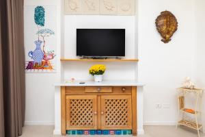 a living room with a tv on a wall at Aria di Mare Vieste - Luxury Apartments by the Sea in Vieste
