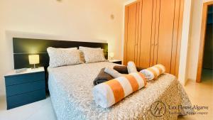 een slaapkamer met een bed met twee handdoeken erop bij Alegria - Shopping Center 150m - Pool - Parking - Terrace in Portimão