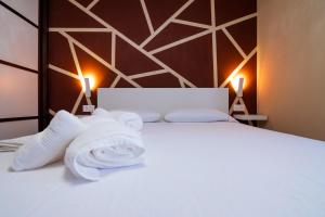 a bedroom with a bed with towels on it at Ninel Home Tenerife in Palm-mar +22 photos