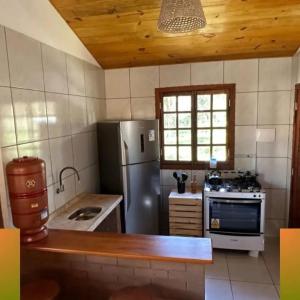 a kitchen with a refrigerator and a stove at Glamping Bio-Dorf Casa 4 in Trairi