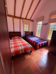 a bedroom with two beds in a room at Sinadan in Barbosa