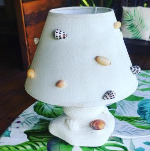 a white lamp sitting on top of a table at Moanaiti Lodge in Maheva