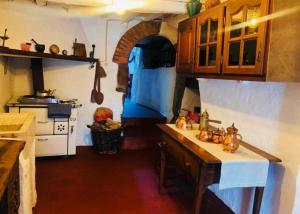 a kitchen with a stove and a sink in a room at Casa Medieval by NaturAlegre in Alegrete