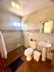 a bathroom with a toilet and a sink at Villa Alexa in La Cana