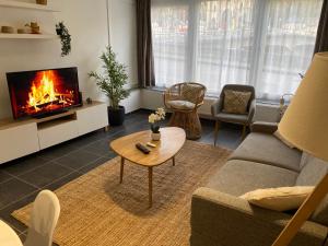 a living room with a couch and a fireplace at Vue Meuse, en face de la citadelle in Dinant