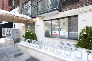 a store front with windows and plants on a street at 75-4B Duplex 3BR Brand new W D Prime UES in New York