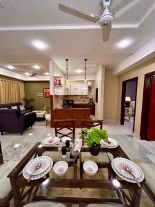 a living room with a table and a couch at Islamabad Oasis Residences in Islamabad