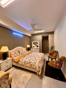 a bedroom with a large bed and a mirror at Islamabad Oasis Residences in Islamabad