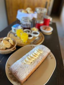 a table with a plate with a piece of bread with bananas on it at Posada Piuquén Suites De Montaña in Barreal