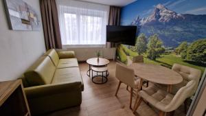 a living room with a couch and a table at Lesíček in Smokovce