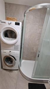a washing machine sitting next to a washer at Lesíček in Smokovce +9 photos