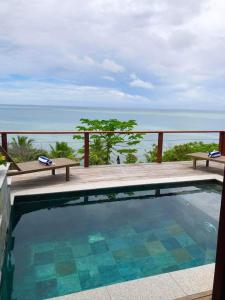 a swimming pool with a view of the ocean at Private Oceanfront Fijian Villa Sleeps 8 in Malolo