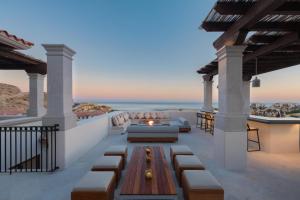 a patio with a fire pit on the roof of a house at Live Aqua Private Residences Los Cabos in Cabo San Lucas