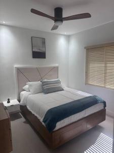a bedroom with a bed with a ceiling fan at ZenCoast in Point