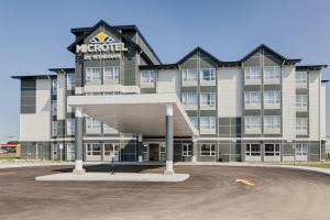 a hotel with a sign on the front of it at Microtel Casselman in Casselman