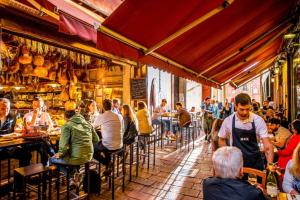 a group of people sitting at tables in a restaurant at Casa Panigale Bologna in Bologna