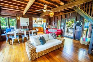 a living room with a couch and a table at The Gallery - Beach hideaway in stunning 1770 in Seventeen Seventy