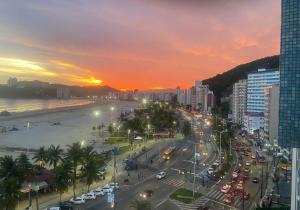 a city with a busy street with traffic at sunset at STUDIO G VISTA ESPETACULAR in Santos