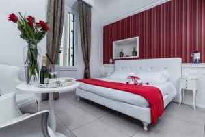 a white bed sitting in a room next to a window at Boutique Hotel La Casa di Morfeo in Florence