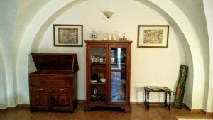 a room with a wooden cabinet and a table at Residenza Le Volte Degli Angeli in Spello