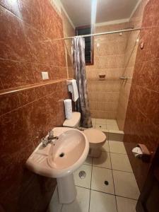 a bathroom with a sink and a toilet at HOSTAl HUAYNA HOUSE in Cusco