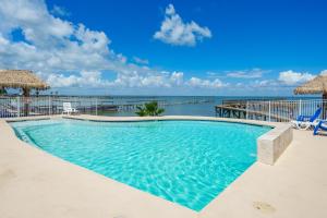 a swimming pool with a view of the ocean at Fishful Thinking ! Pool on the waters edge in Rockport