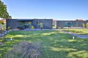 a house in a yard with a green lawn at Targowa37 Uniejow in Uniejow
