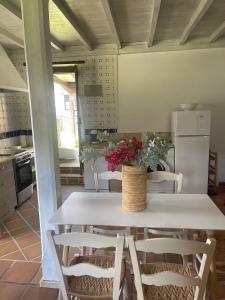 a kitchen with a table with flowers on it at Casas Rurales La Torre Andrín in Andrín