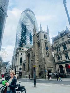 a woman is standing in front of a building at Brockmer House in London