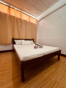 a bed in a room with a white mattress at Duchess Sophia's Pension in Puerto Princesa City