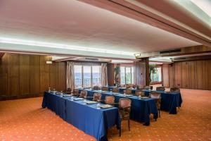 a large room with blue tables and chairs in it at Rigat Park & Spa Hotel - Adults Recommended in Lloret de Mar