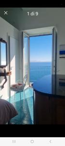 a room with a large glass door with a view of the ocean at Casa Gargano Ravello Amalfi Coast in Amalfi