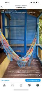 a hammock on the porch of a house at Pousada Lua Bonita in Nova Lima