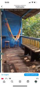 a hammock on the porch of a blue house at Pousada Lua Bonita in Nova Lima