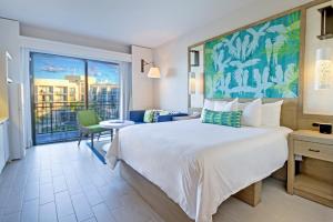 a hotel room with a bed and a large window at Margaritaville Vacation Club - Rio Mar in Rio Grande