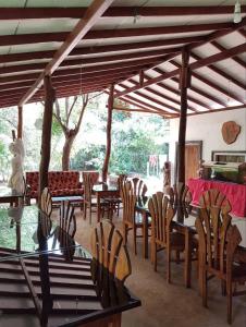 a dining room with a table and chairs and a table and chairsktop at Sigiriya Samanala Guest in Sigiriya