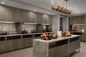 a large kitchen with a counter with fruits in baskets at TownePlace Suites by Marriott Abilene Southwest in Abilene