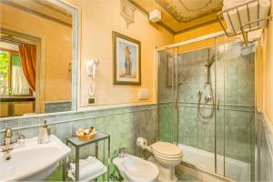 a bathroom with a shower toilet and a sink at Firenze Suite in Florence